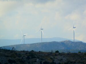 white wind turbines on green grass field during daytime